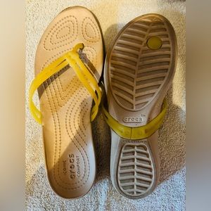 Tan flip flops with petite yellow strap, size 8.